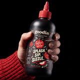 Hand squeezing the flexible opaque Goodia bottle